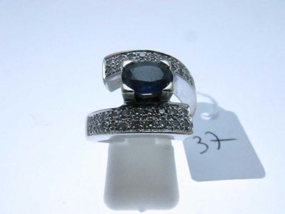 1 white gold ring set with a central sapphire...