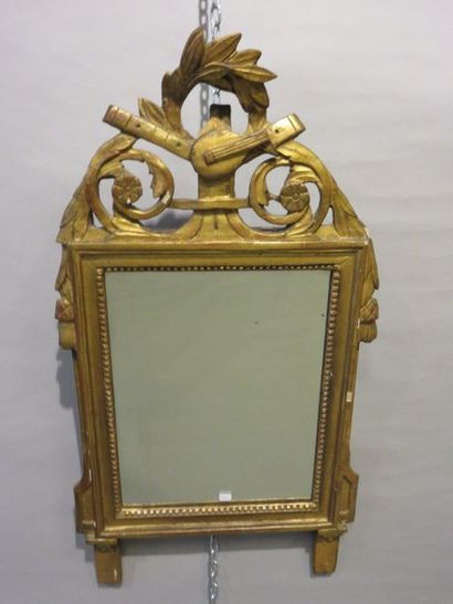 GLACE Gilded wooden mirror with musical instrument decoration. Louis XVI period....