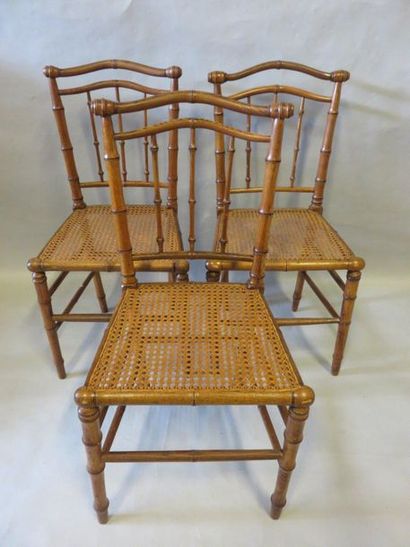CHAISES Three caned chairs in natural wood bamboo style. One bamboo-straw chair and...