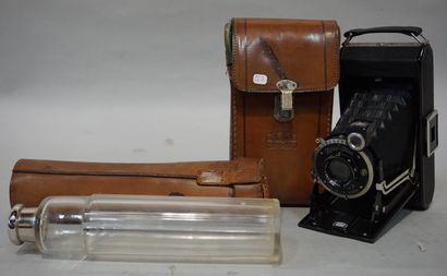null Zeiss Ikon bellow camera and bottle in its case.