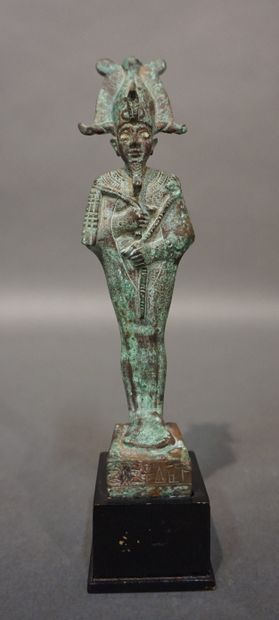 Statuette of Osiris standing and wearing...
