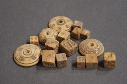 null Set of twelve playing dice and four spindle whorls. Bone. Small chips. Egypt,...