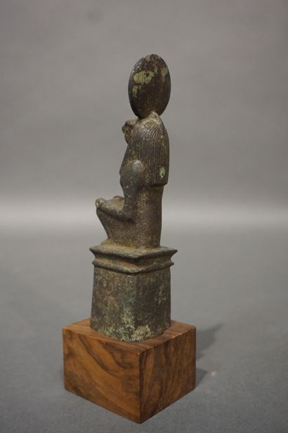 null Anthropomorphic statuette with a hawk's head wearing a solar disk and a striated...