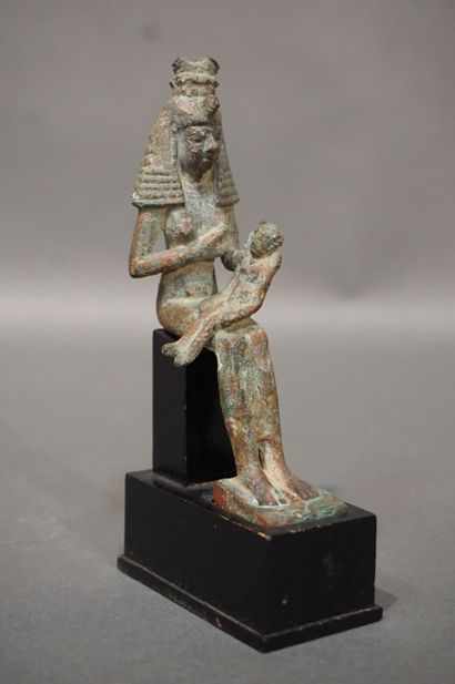 null Statuette of Isis lactans. Isis is represented with a large wig topped with...