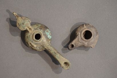 null Lot including a long-spouted oil lamp of Hellenistic type with leaf-shaped reflector...