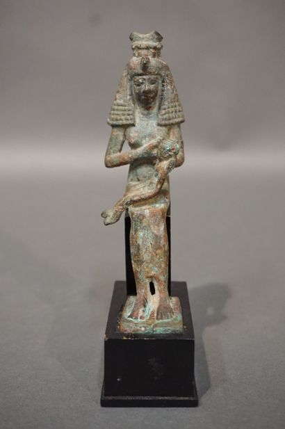 null Statuette of Isis lactans. Isis is represented with a large wig topped with...