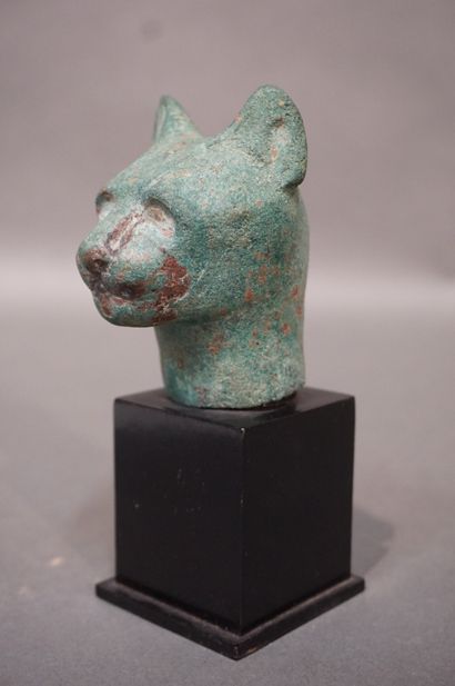 null Head of a cat of Bastet, the eyes formerly inlaid. Bronze with green patina....
