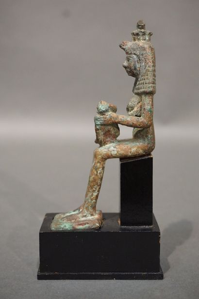 null Statuette of Isis lactans. Isis is represented with a large wig topped with...