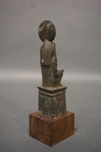 null Anthropomorphic statuette with a hawk's head wearing a solar disk and a striated...