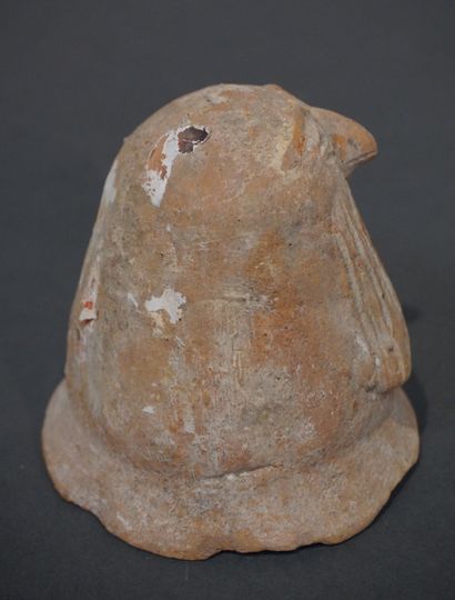 null Stopper of vase canope in the shape of stylized head of Kébehsénouf. Ochre terracotta....