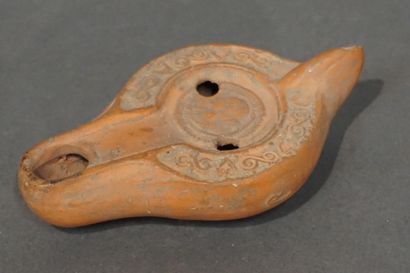 null Oil lamp with a channel spout decorated with a medallion representing a female...