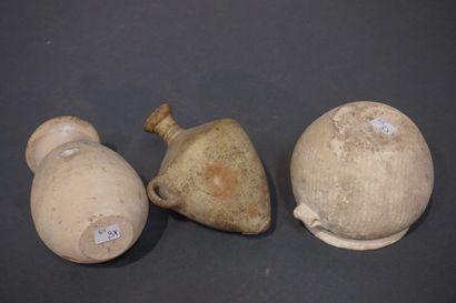 null Lot including a pitcher with ovoid body and horizontal lip, a jar with truncated...