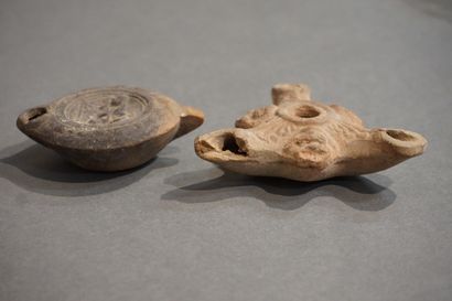 null Lot of two oil lamps, one with a round spout with a medallion representing a...