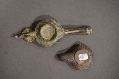 null Lot including a long-spouted oil lamp of Hellenistic type with leaf-shaped reflector...