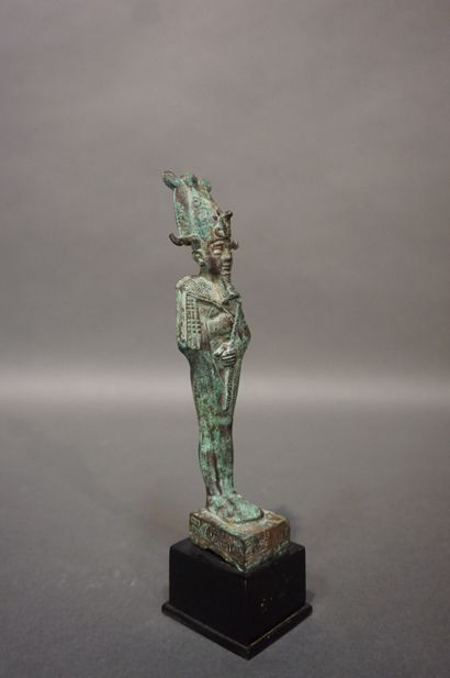 null Statuette of Osiris standing and wearing the Atef crown, the posticular beard,...