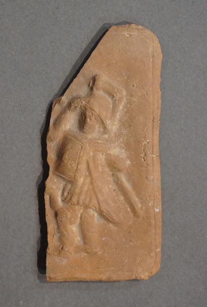 null Fragment of a plaque in bas-relief representing Athena fighting a character...