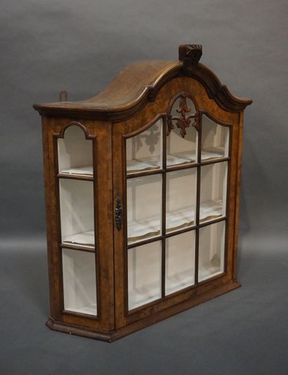 Vitrine Small hanging display case in walnut and walnut veneer; the pediment with...