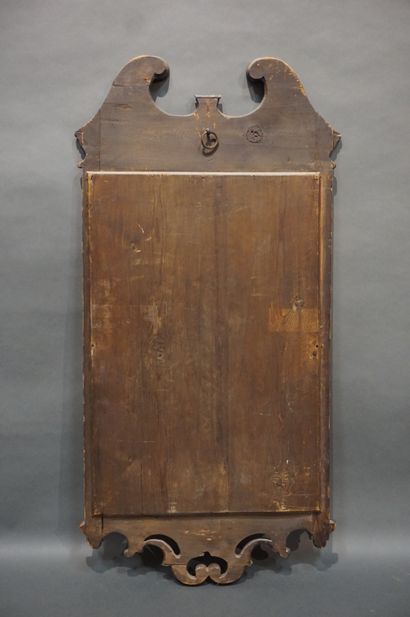 MIROIR Mahogany and mahogany veneer mirror; the pediment with confronted brackets;...