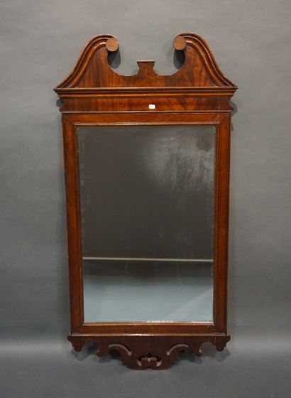 MIROIR Mahogany and mahogany veneer mirror; the pediment with confronted brackets;...