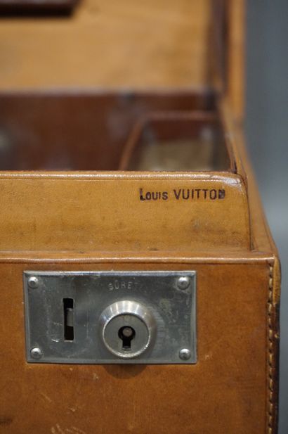 LOUIS VUITTON 
Valise de toilette en cuir, monogrammé N.L., anse cassée. Flacons...