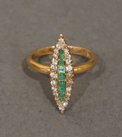 Denis Gold ring signed DENIS of navette shape set with nine emeralds and twenty-four...