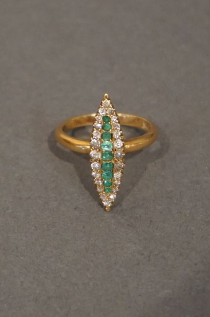 Denis Gold ring signed DENIS of navette shape set with nine emeralds and twenty-four...