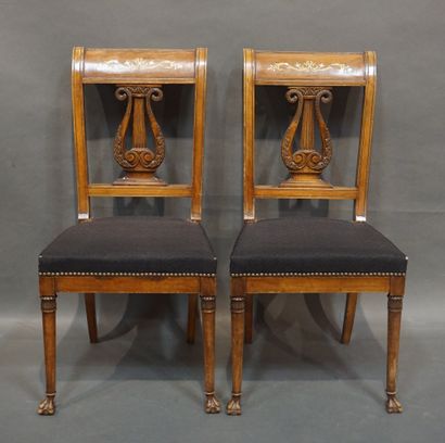 null 
Six carved natural wood chairs with lyre backs, brass inlaid bands and claw...