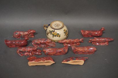 null Gien earthenware cup and eleven animal knife holders in red ceramic.
