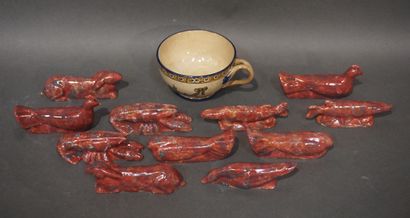 null Gien earthenware cup and eleven animal knife holders in red ceramic.