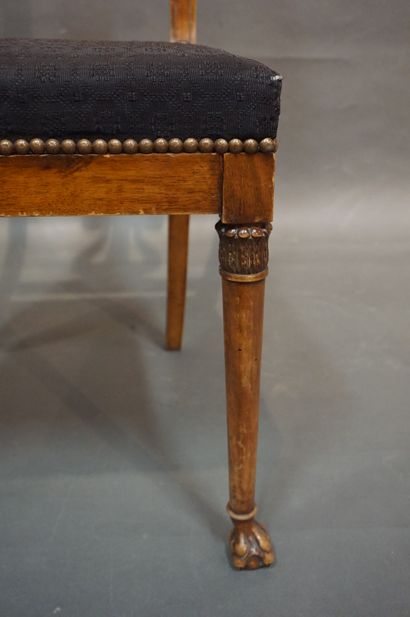 null 
Six carved natural wood chairs with lyre backs, brass inlaid bands and claw...