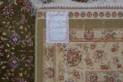 null Carpet with vegetal decoration on a green background with cream border. 180x119...