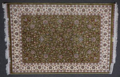null Carpet with vegetal decoration on a green background with cream border. 180x119...