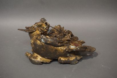 null Asian statuette in metal with golden patina: "Man sitting on a demon" (oxidation)....