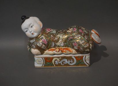 null Asian porcelain box with lid in the shape of a reclining child. 19x28x12 cm