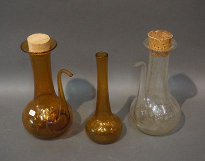 null Two bubble-glass oil carafes and soliflore vase (23 cm), signed Biot, amber...