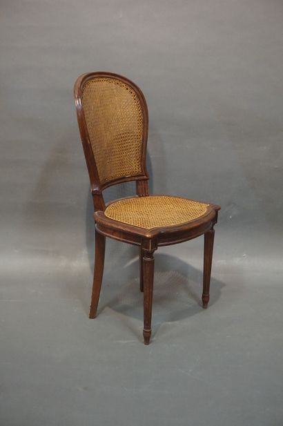 null Twelve caned chairs in molded natural wood with fluted legs. Louis XVI style...