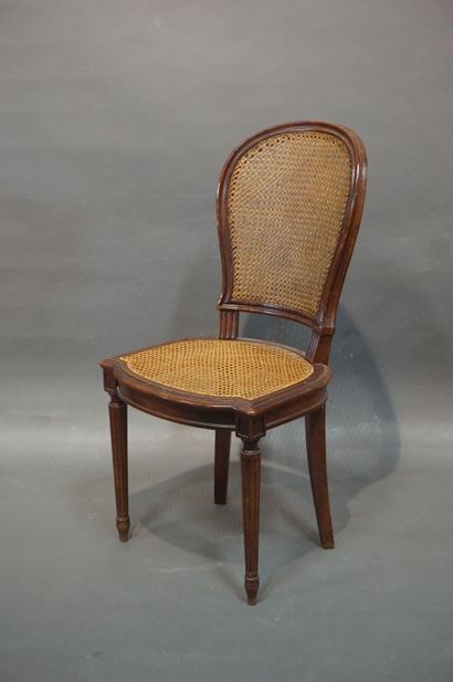 null Twelve caned chairs in molded natural wood with fluted legs. Louis XVI style...