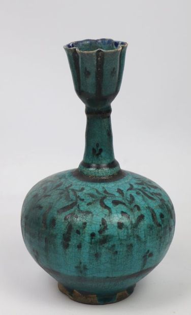 null Bottle vase

Siliceous paste with black decoration under a turquoise glaze

Iran,...