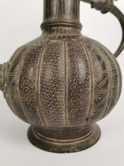 null Ewer with zoomorphic decoration.

Bronze.

India, 19th-20th century.

H_ 34.2...