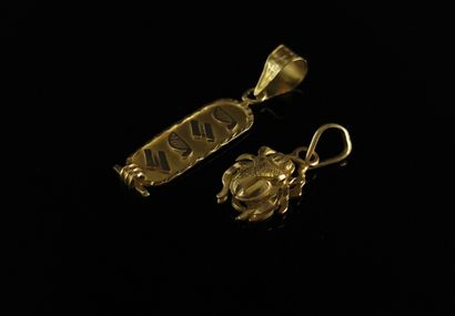 null Two yellow gold pendants with scarab and hieroglyphic decoration. 

weight:...