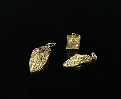 null Trois pendentifs en or jaune formant deux babouches et un Coran miniature, une...