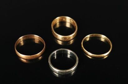null Meeting of four wedding rings in yellow, white and pink gold, three with flattened...