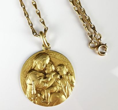 null Yellow gold necklace holding a yellow gold medal decorated in bas-relief with...