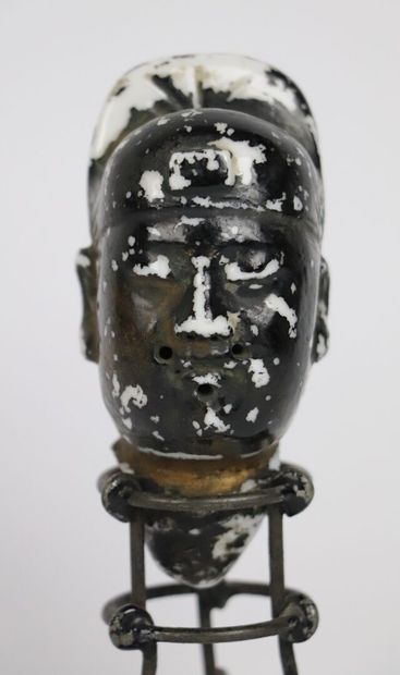 null CHINA.

Head of Buddha in white porcelain lacquered black and gold. 

On its...