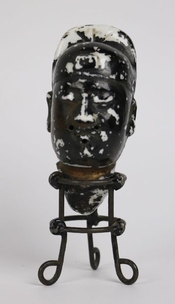 null CHINA.

Head of Buddha in white porcelain lacquered black and gold. 

On its...