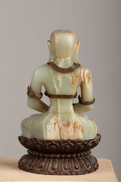 null CHINE, XIXème siècle.

Bouddha assis en jade sculpté, orné d'une parure de bronze...