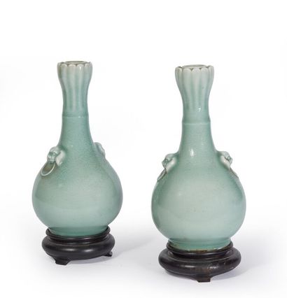 null CHINA.

A pair of celadon enameled porcelain piriform vases, the handles applied...