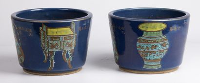null CHINA, 20th century. 

Pair of blue glazed stoneware planters with rotating...