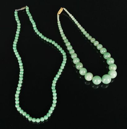  Two green jade beads necklaces, one with...