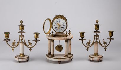 null Bronze and marble mantelpiece. 

The terminal clock with enamelled dial resting...